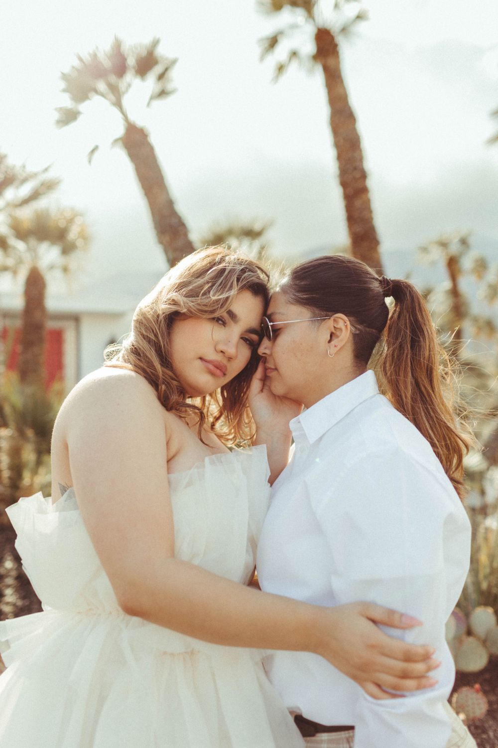 two women embrace, recently engaged in Palm Springs, California