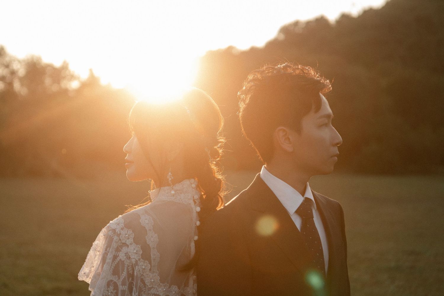 A romantic sunset silhouette shot of a couple during their golden hour wedding photography session.