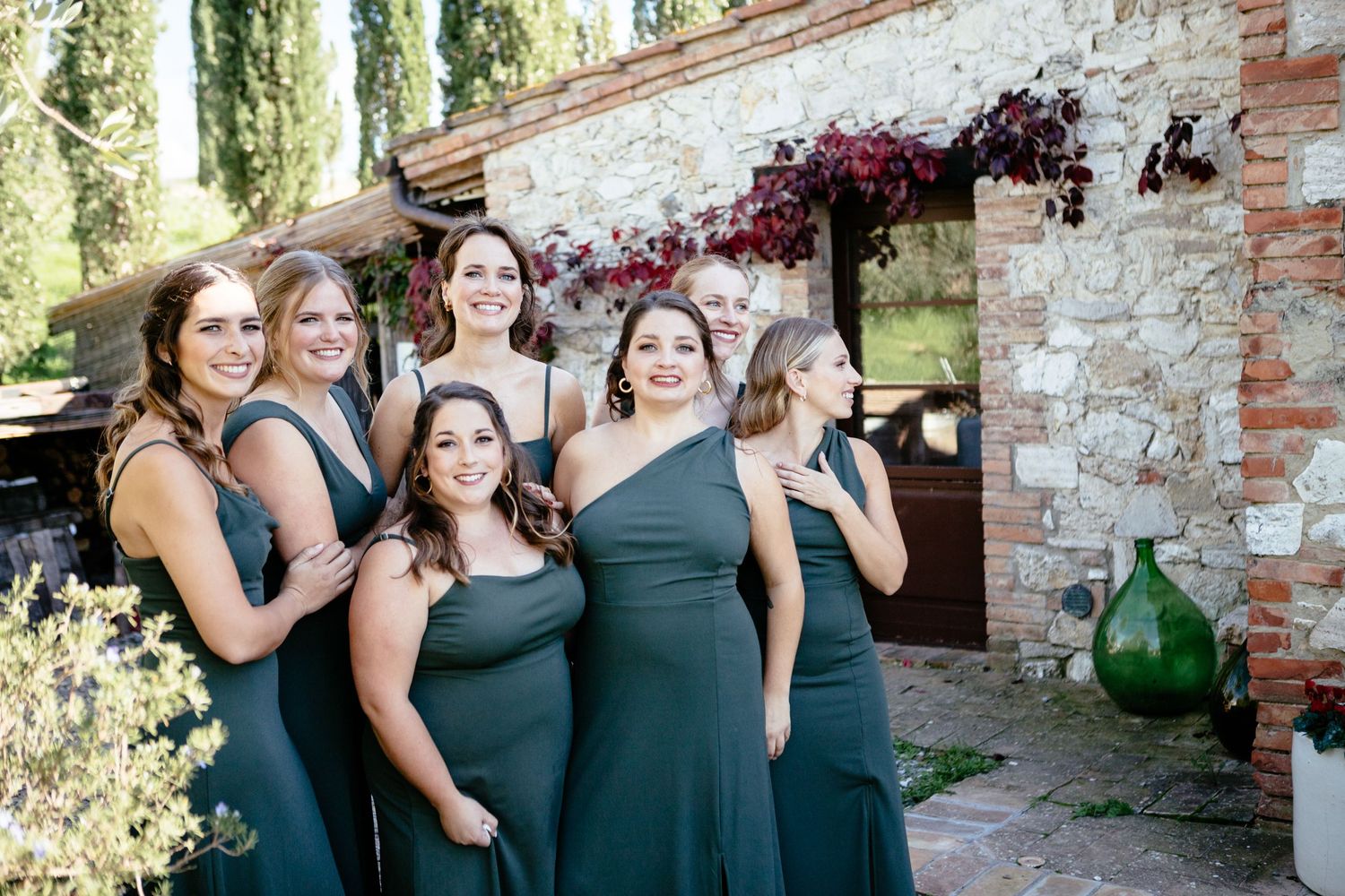 Bridesmaids in green dresses wait for the bride at this Tuscany destination wedding.
