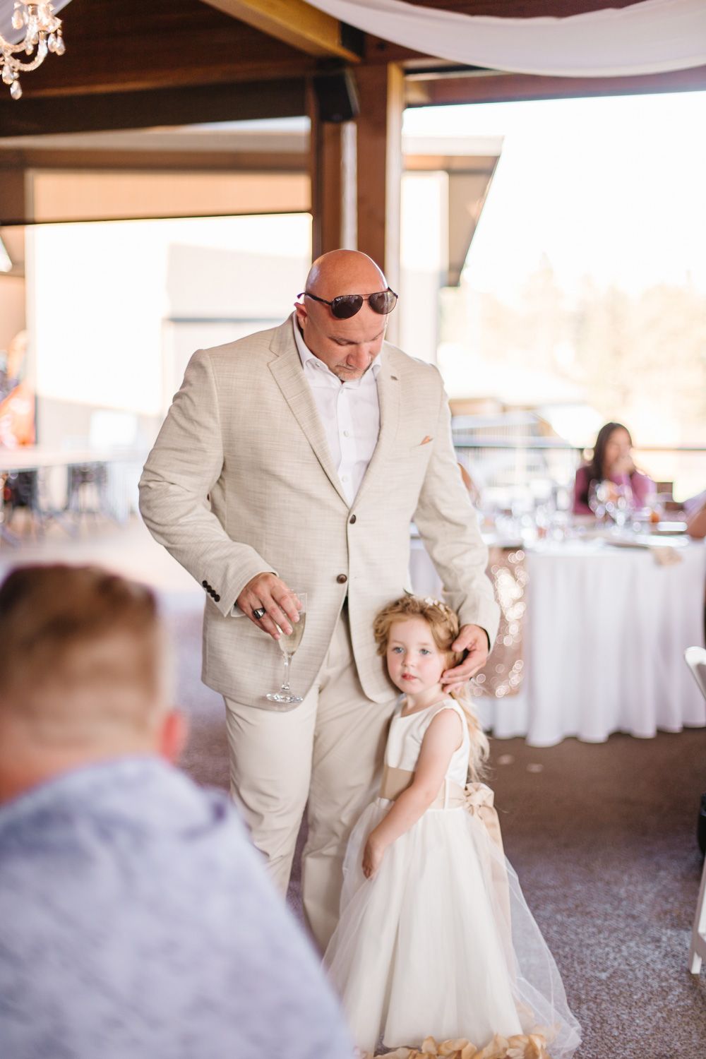 A heartwarming first dance between a parent and child at an indoor wedding reception.