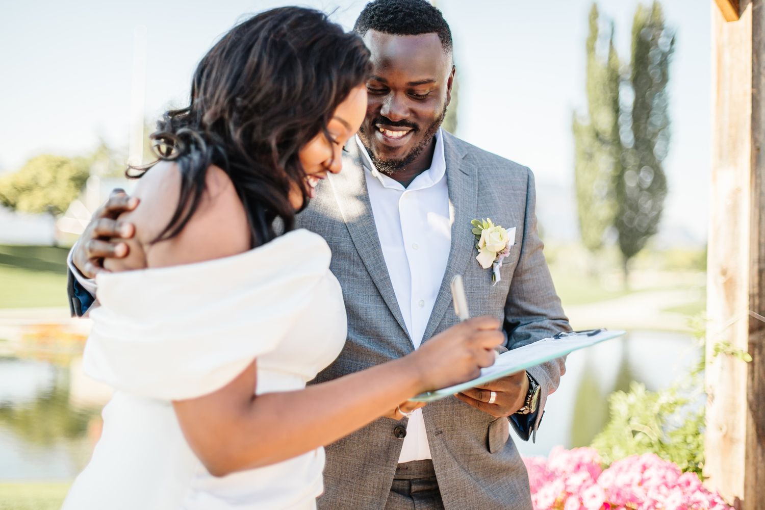 Newlyweds share an emotional moment during their first look in a garden setting.