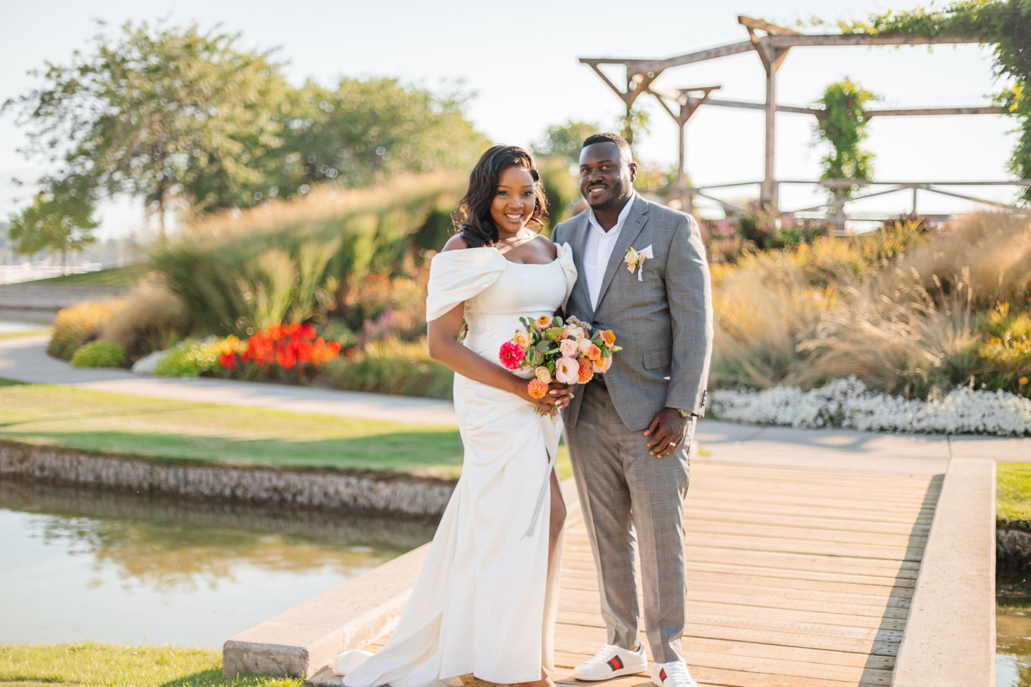 Wedding ceremony setup with wooden arbor and chairs overlooking a scenic waterfront view.