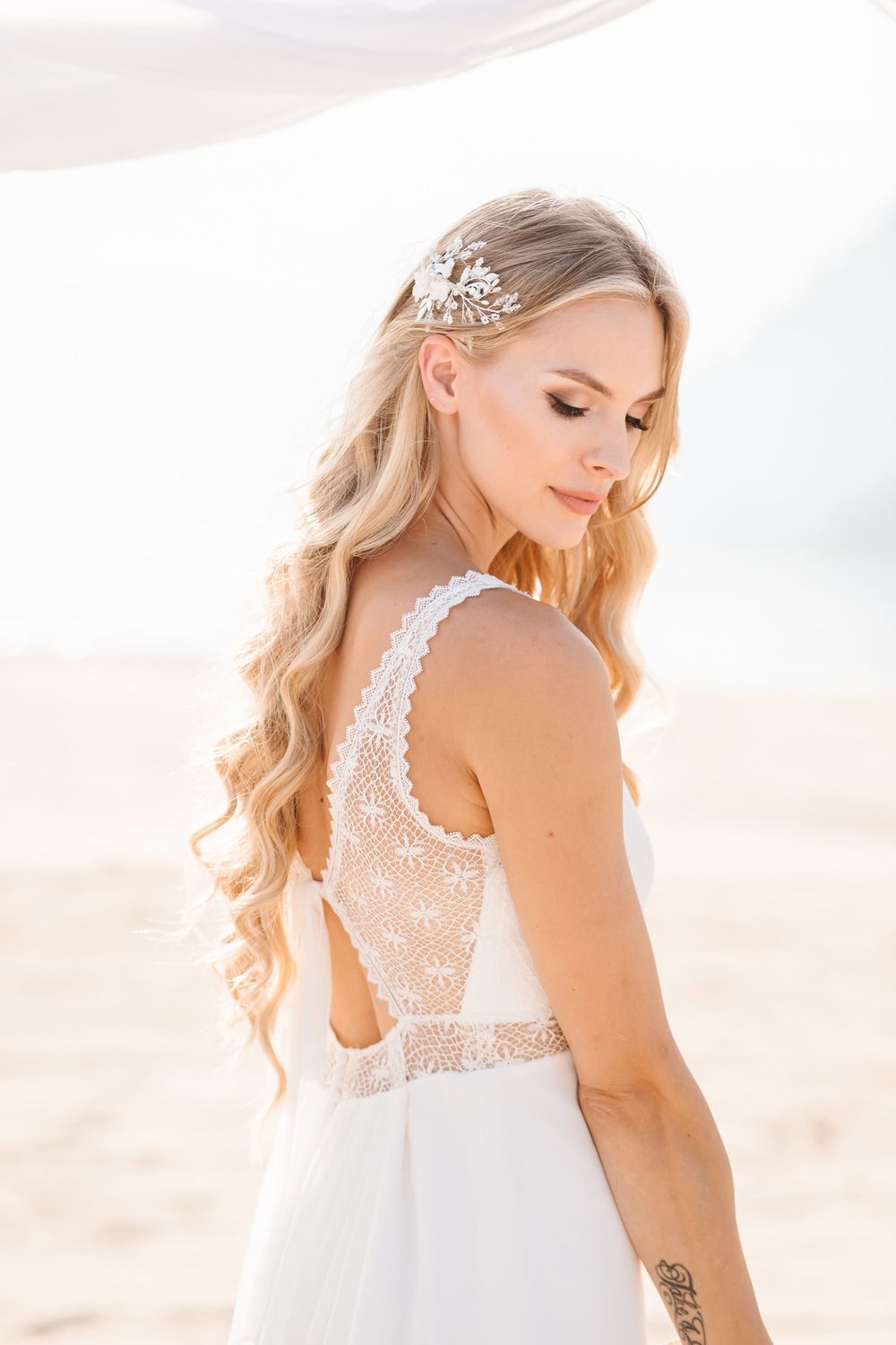 Close-up details of intricate lace back on white wedding gown.