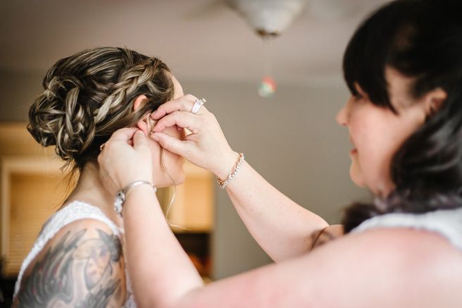 Getting ready moments captured in soft indoor lighting.