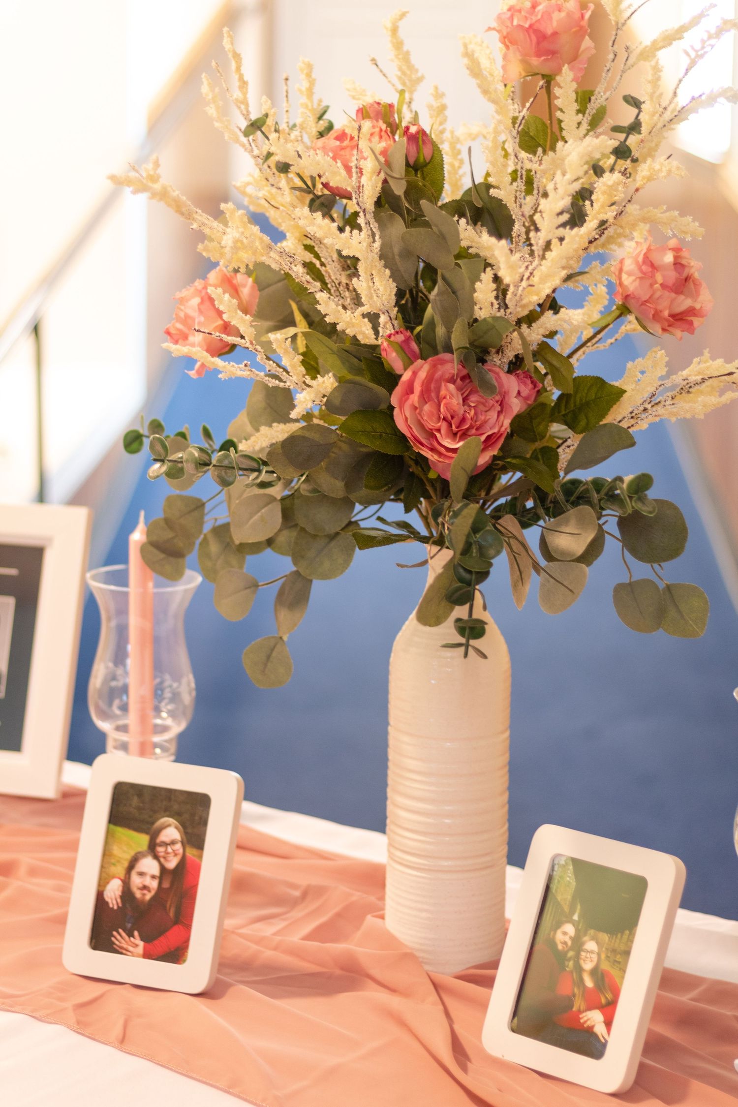 Alternative view of the table and flower arrangement using pink florals and eucalyptis