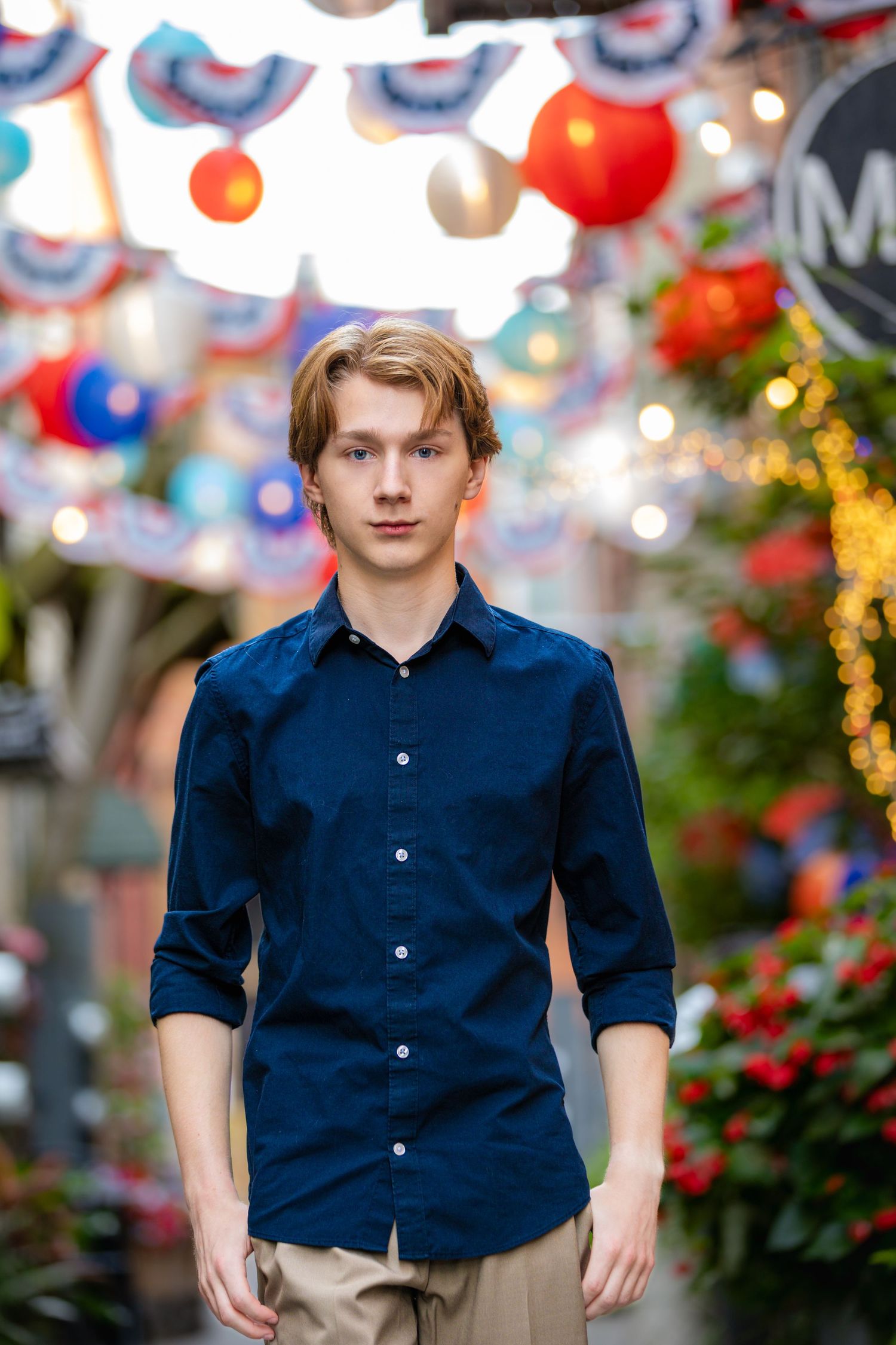 High school senior portrait in The Alley District, Howell Michigan; boy walking downtown by Brighton, MI photographer
