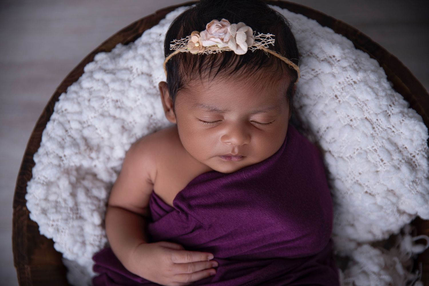 sweet baby girl posing for her newborn session with gold coast's favourite newborn photographer