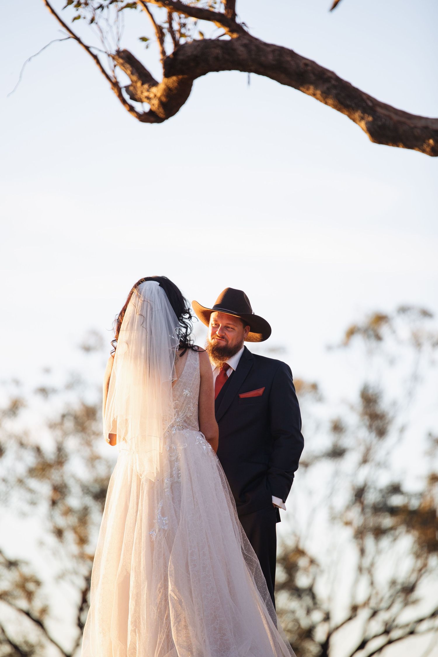 Kylie and Jono sharing private wedding vows on a mountaintop near Moonan Cottage