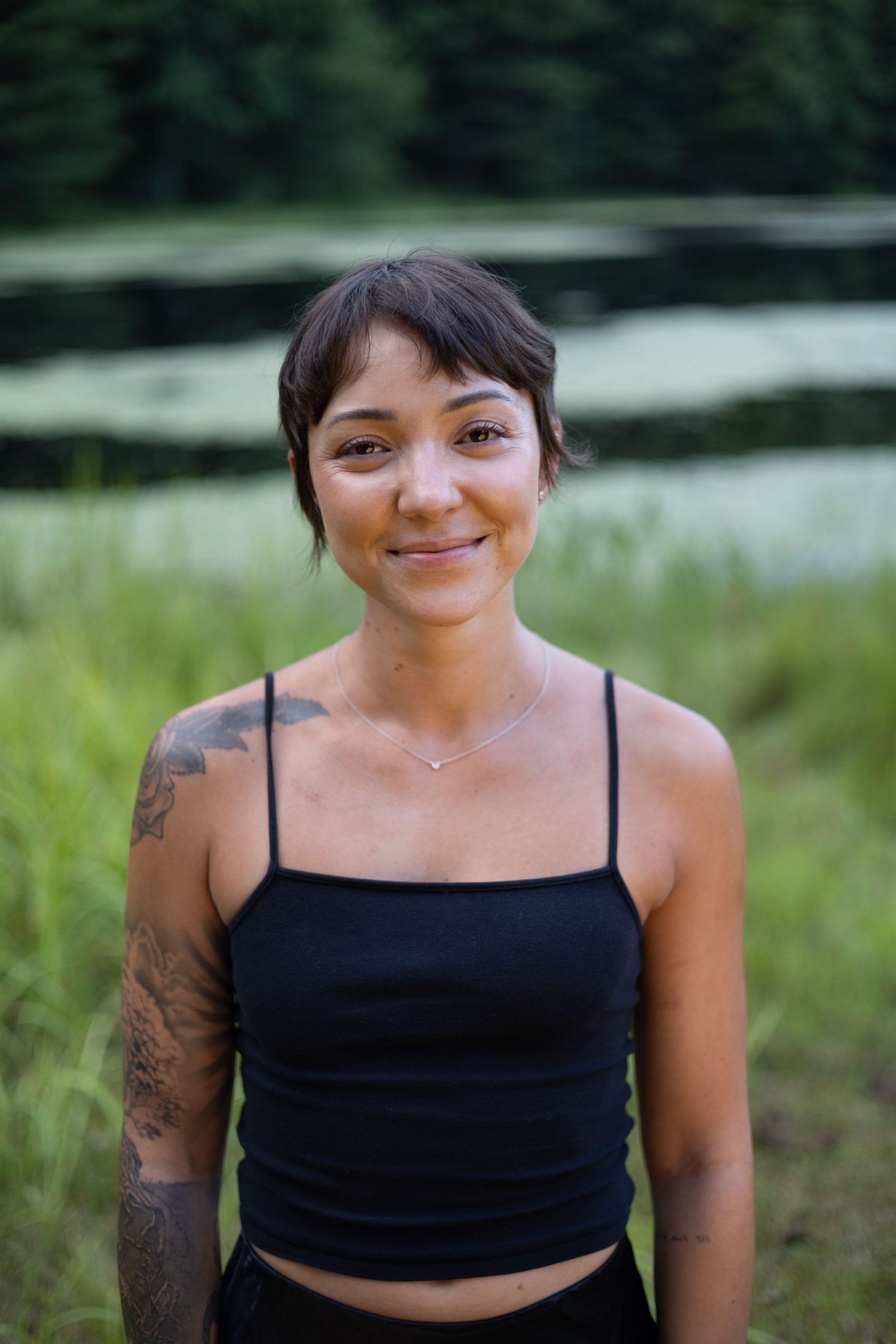 Portrait of a woman smiling near a pond