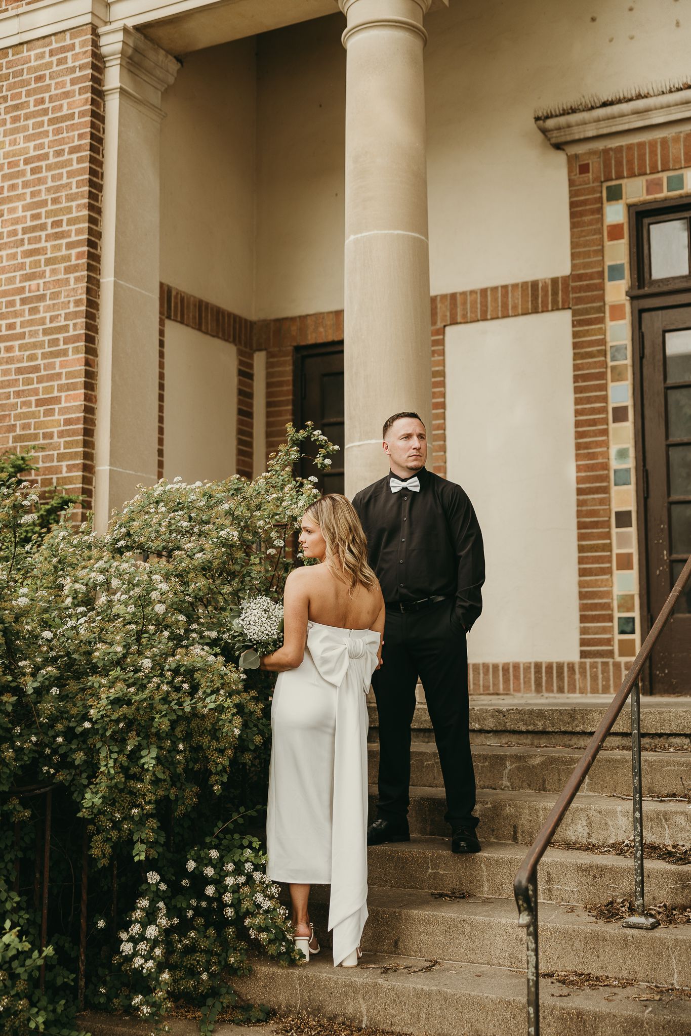 Iowa couple posing in front of a historical building in mason city Iowa. Photography for those who love documentary and editorial photograph