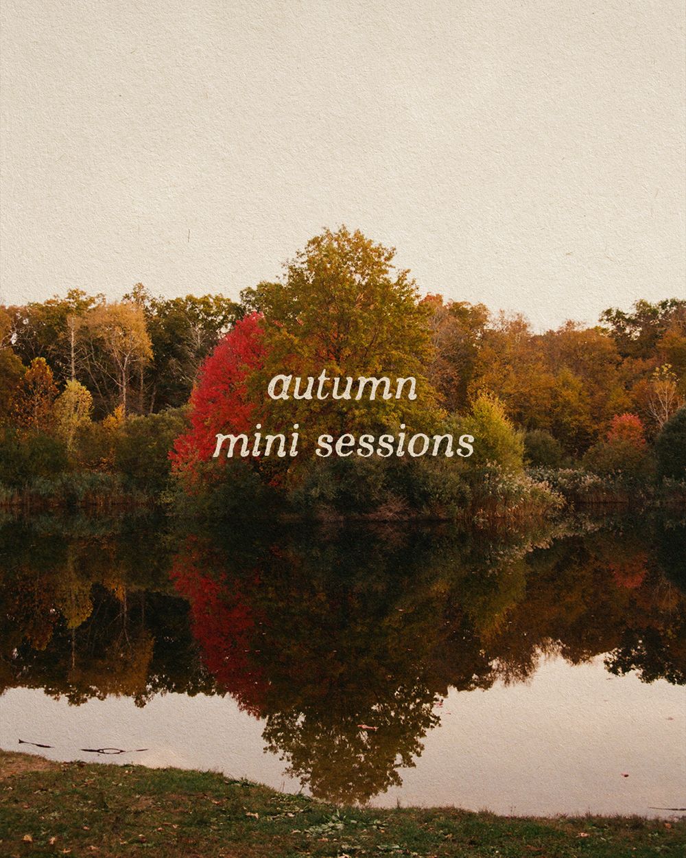 Autumn mini sessions promotional photo featuring colorful fall trees reflecting in a calm lake on a misty day.