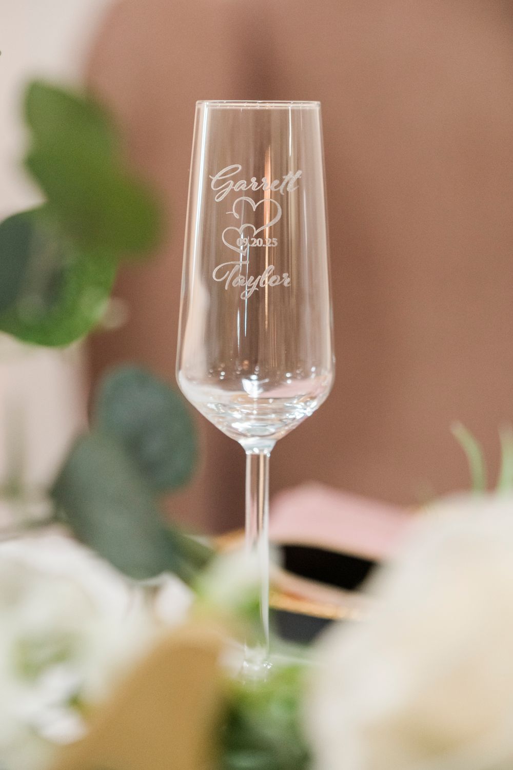Personalized engraved champagne flute with couple names Garrett and Taylor, elegant wedding toast glass.