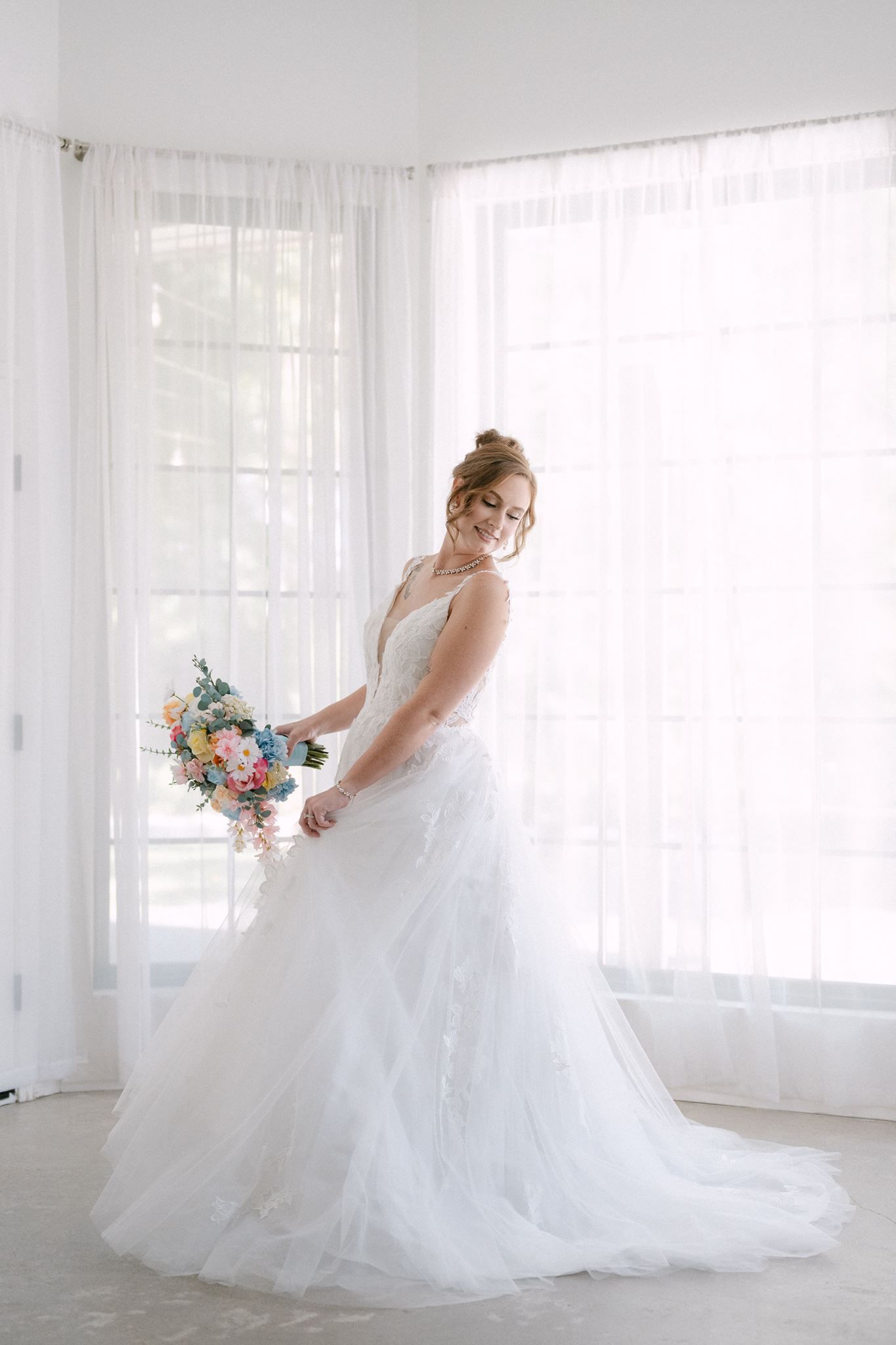 Bride twirling in her wedding dress at Oak Atelier in Conroe Tx.