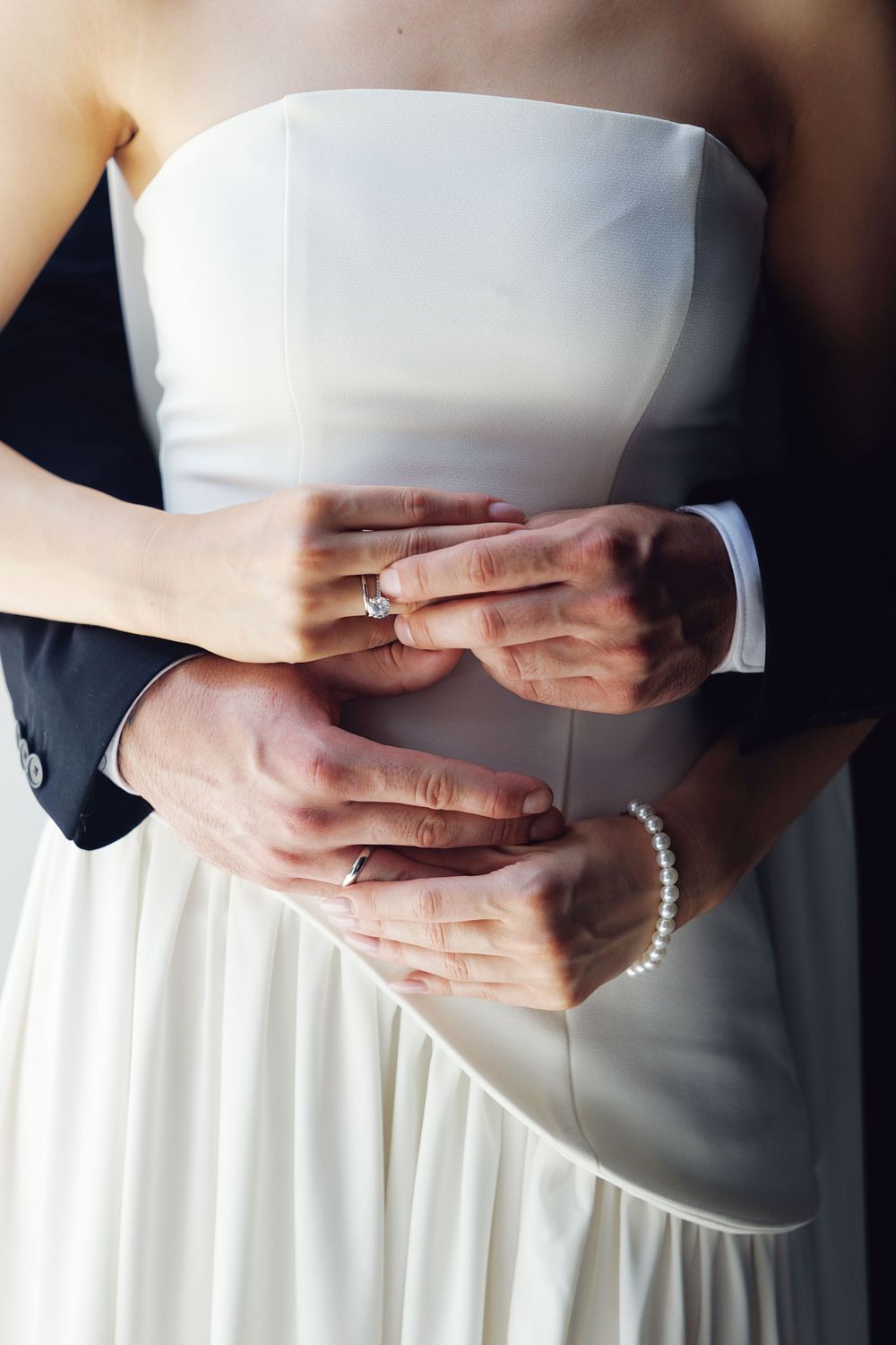 Close-up of bride and groom’s hands with wedding rings