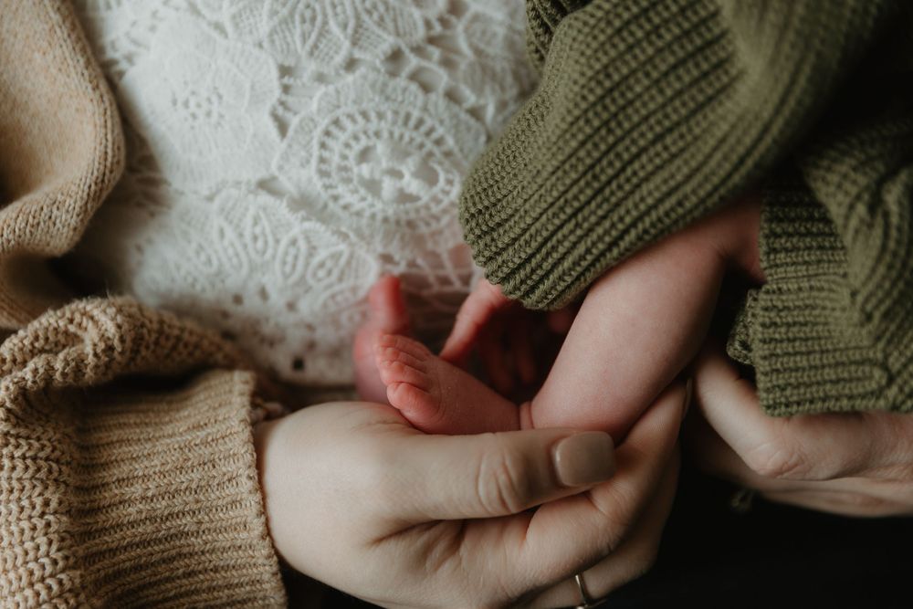 capturing feet Detail shots of precious newborn so tiny in mothers hand Tyler Tx Motherhood story-telling photographer