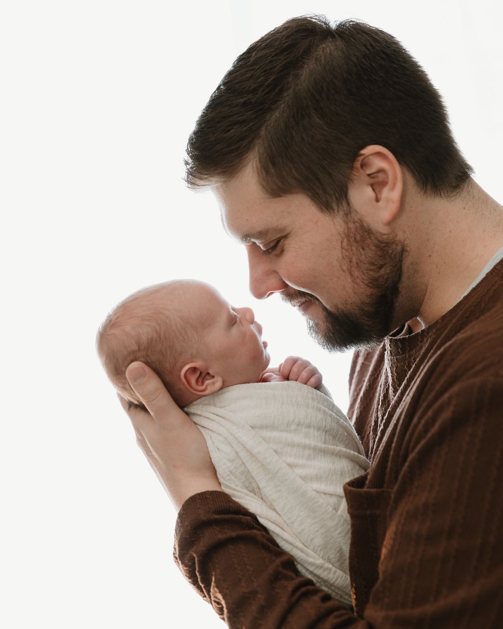 Glowing Dad with Baby image during in-home newborn lifestyle session with Tyler Tx newborn photographer