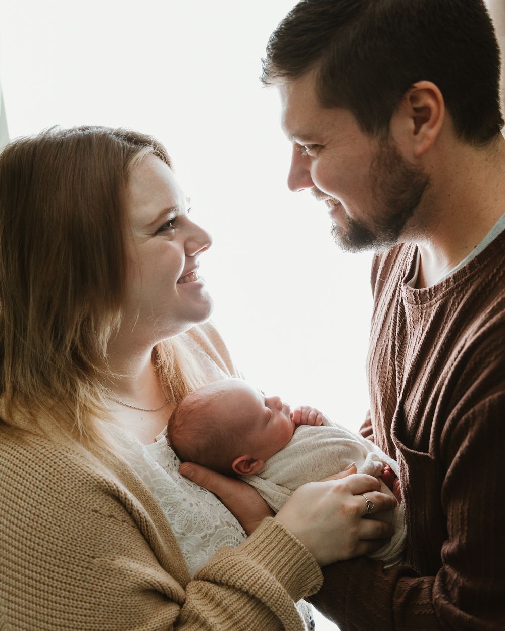 Parent silhouette image with newborn during lifestyle newborn portrait session with East Tx photographer