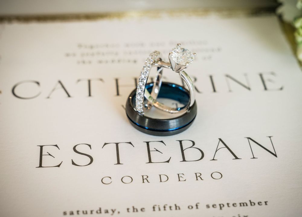 Wedding rings resting on an elegant invitation for Catherine and Esteban Cordero, Saturday the fifth of September.