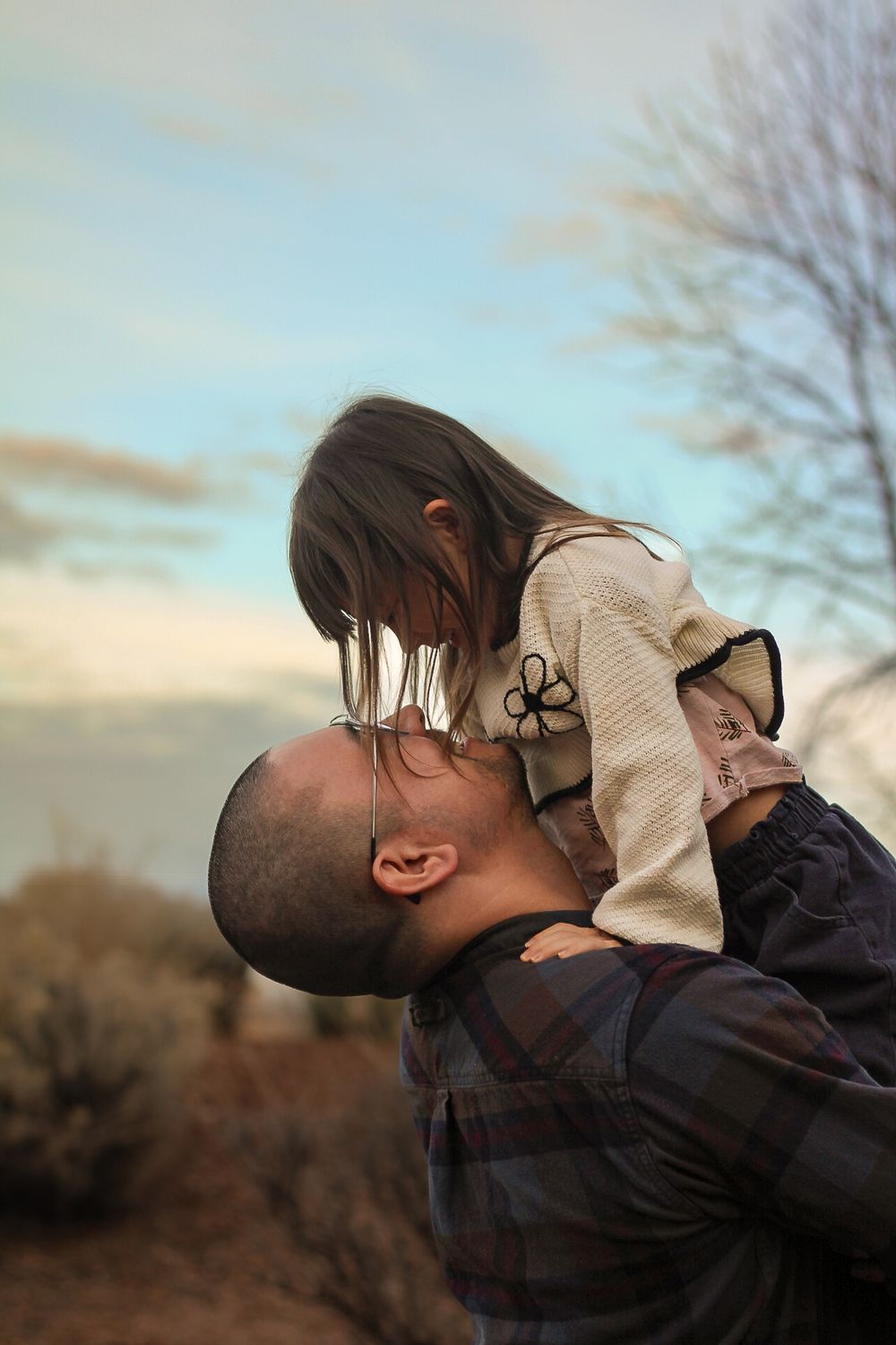 Father lifting young daughter portrait session in Rio Rancho, NM.