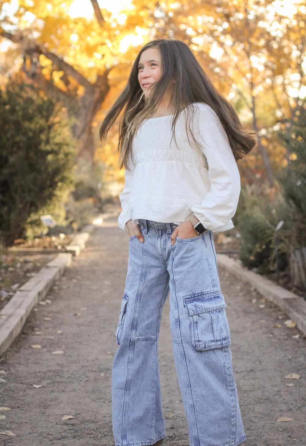Middle school aged girl twirling in Bosque