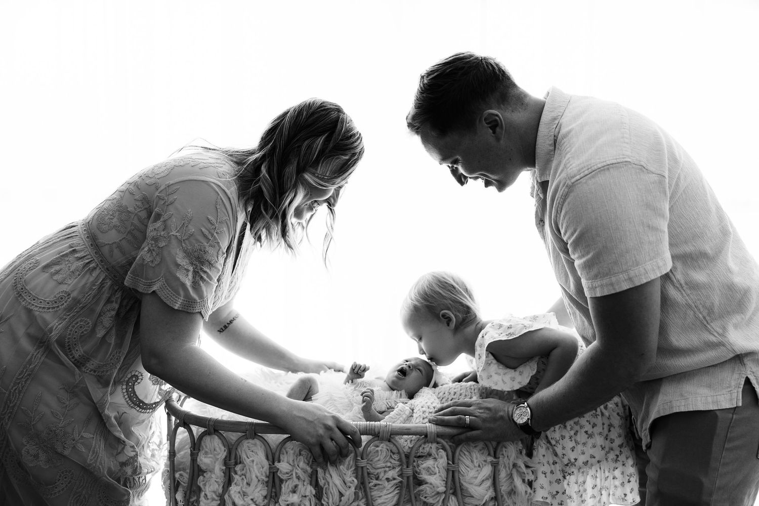 Wrapped mini newborn session in Magnolia TX featuring neutral newborn photography with baby posed in baskets and natural-toned props by Anna