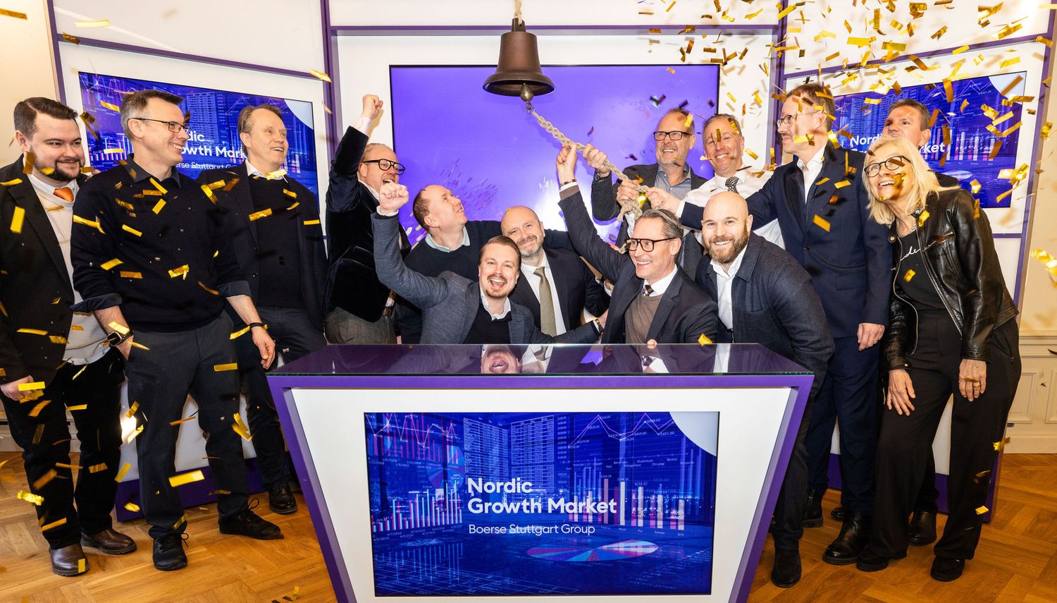 Group celebrating a Nordic Growth Market stock exchange bell-ringing ceremony on the trading floor.