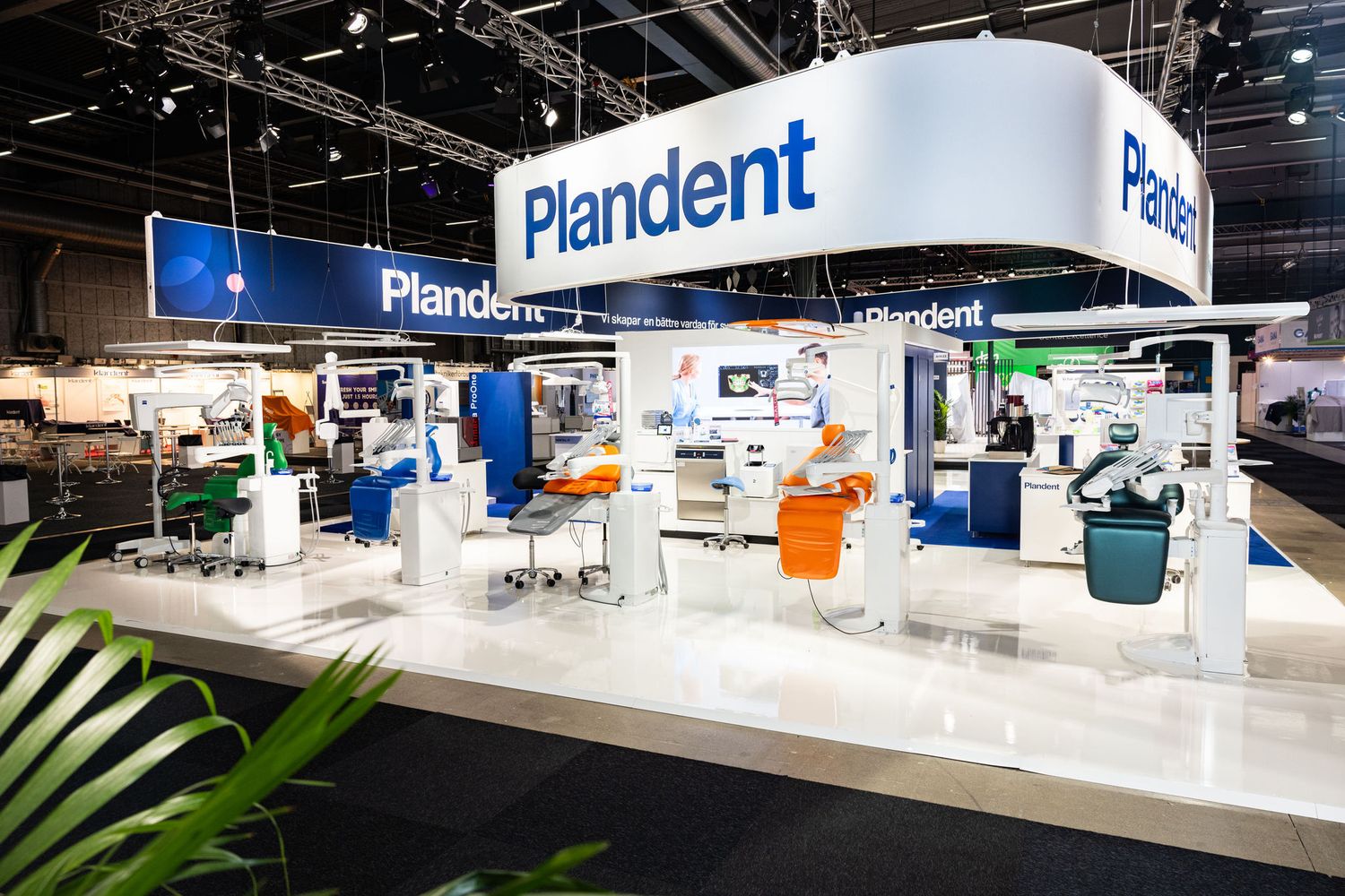 Modern Plandent dental equipment exhibition stand displaying dental chairs and technology.