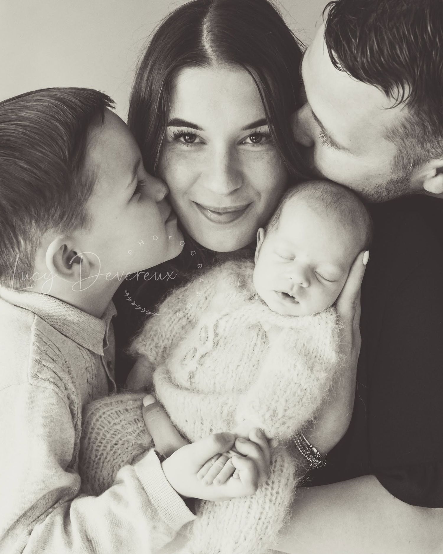 Mum in the middle. Mum, Dad, son and newborn baby daughter. Joyous. Black and white. Family newborn session
