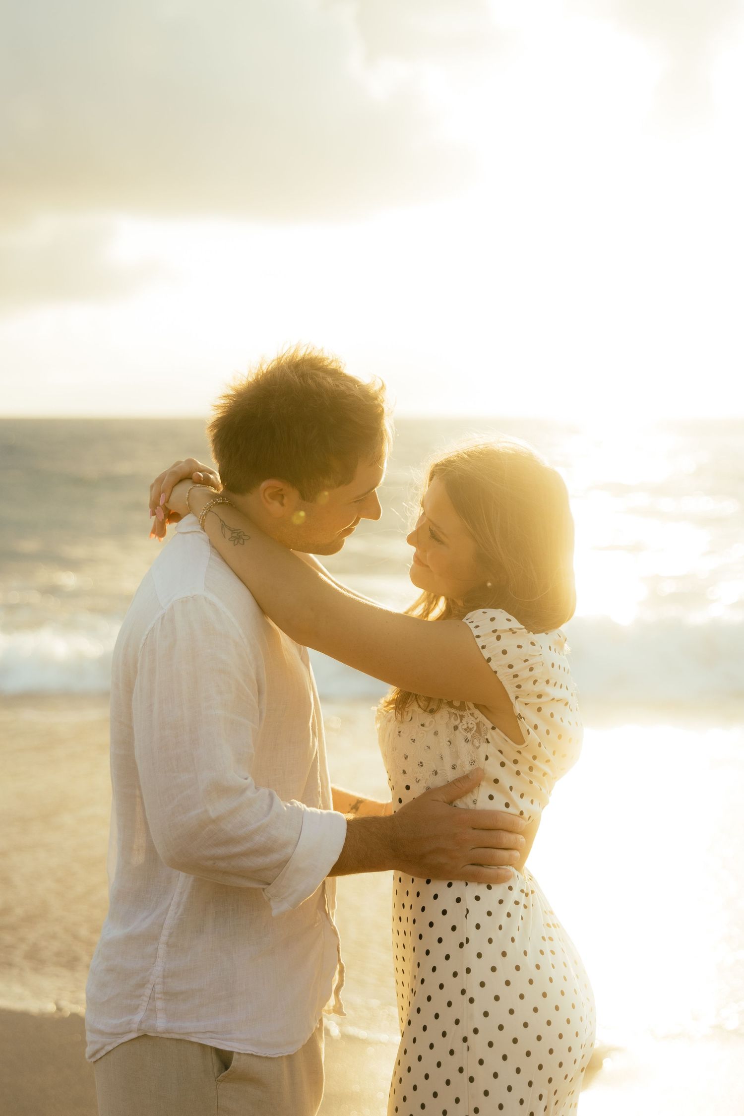 Playful sunrise beach engagement photos with golden light and bright blue waters. Jacksonville Engagement Photographer - Lindsay McDow Photo