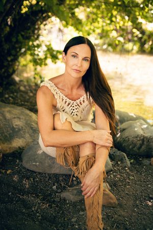 Salt Lake City Utah Water Boudoir Photography by Carl James. Woman in river surrounded by green trees, posing in natural outdoor setting.