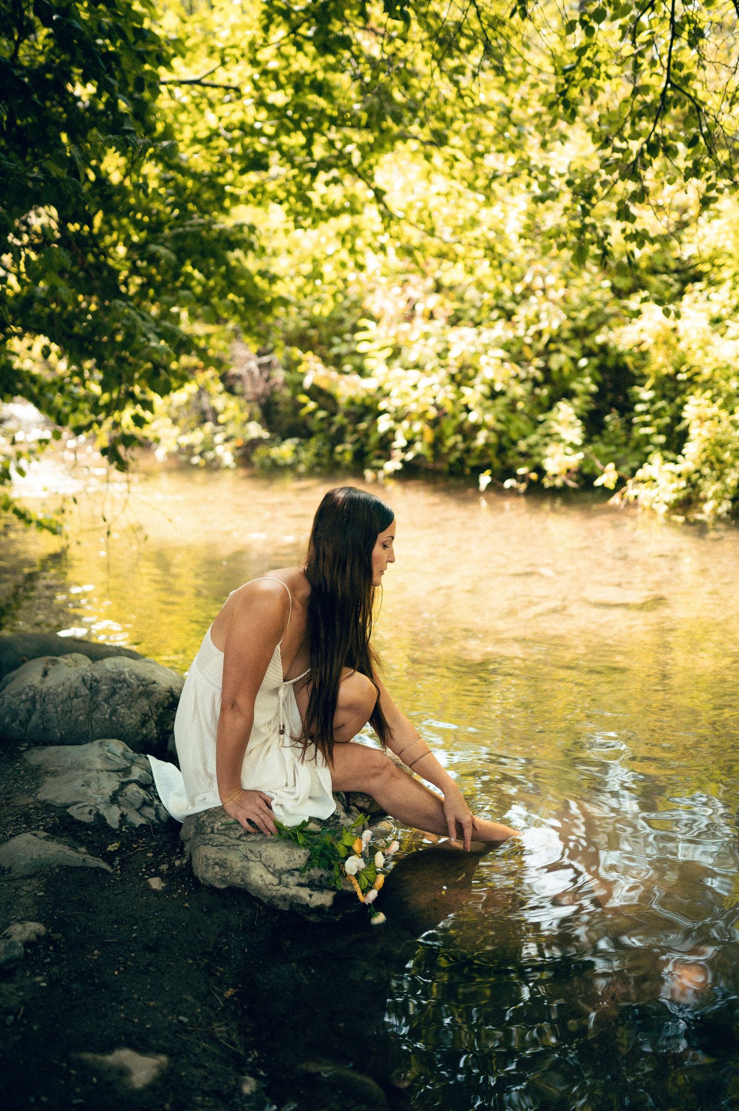 Salt Lake City Utah Water Boudoir Photography by Carl James. Woman in river surrounded by green trees, posing in natural outdoor setting.
