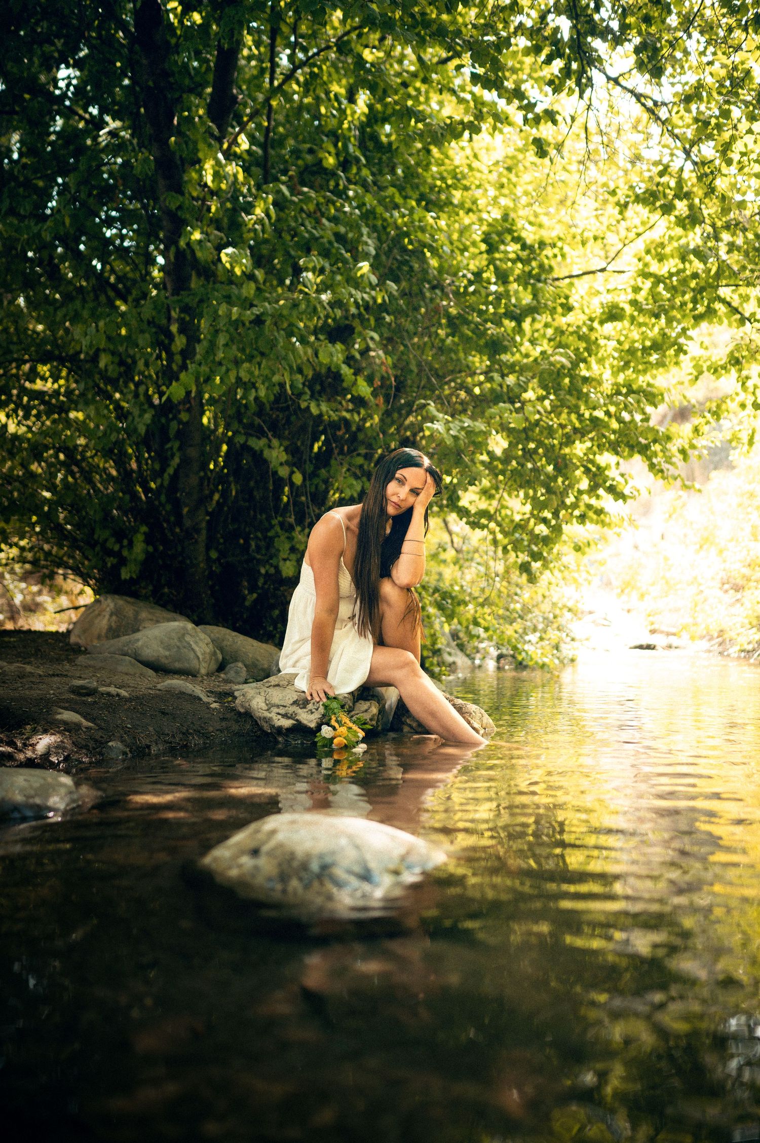 Salt Lake City Utah Water Boudoir Photography by Carl James. Woman in river surrounded by green trees, posing in natural outdoor setting.