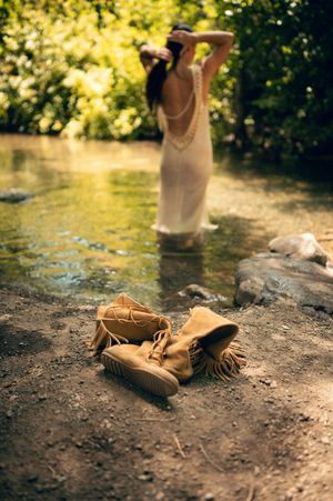 Salt Lake City Utah Water Boudoir Photography by Carl James. Woman in river surrounded by green trees, posing in natural outdoor setting.