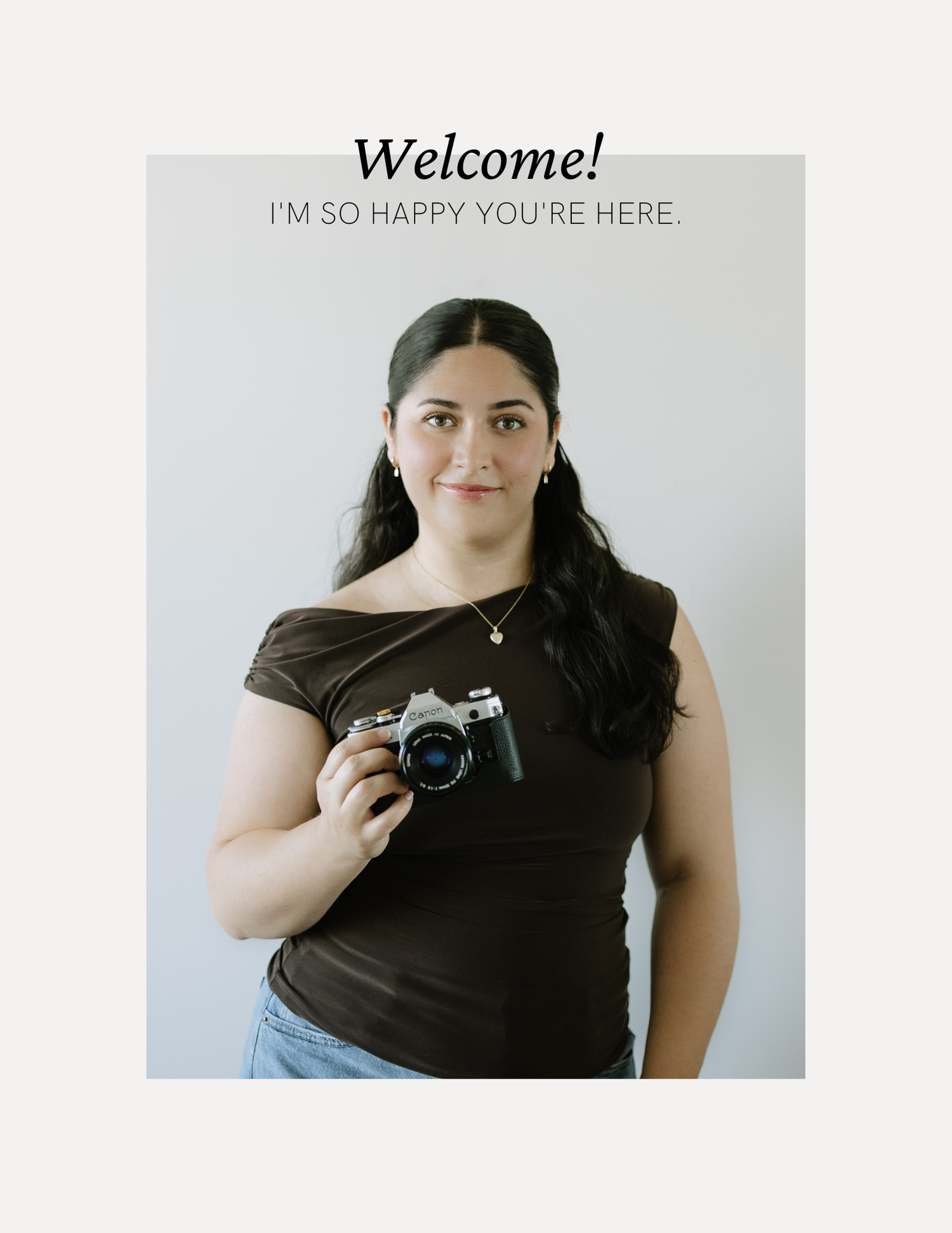 A young woman holding a film camera wearing a dark top, with text reading Welcome, I'm So Happy You're Here.