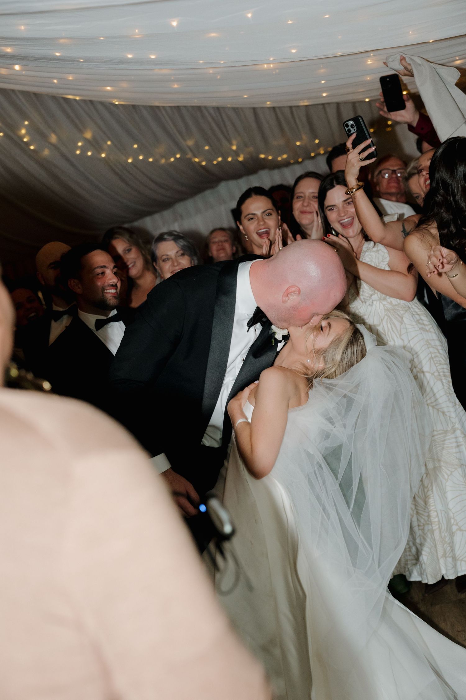 Bride and groom share a romantic dip kiss during wedding reception. Mudgee Wedding Photography. The Vinegrove Mudgee. Live saxaphone wedding