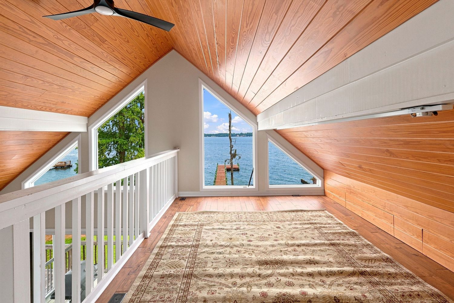 Cozy loft seating area featuring large windows with a scenic river view, shot for an Eastern NC Home.