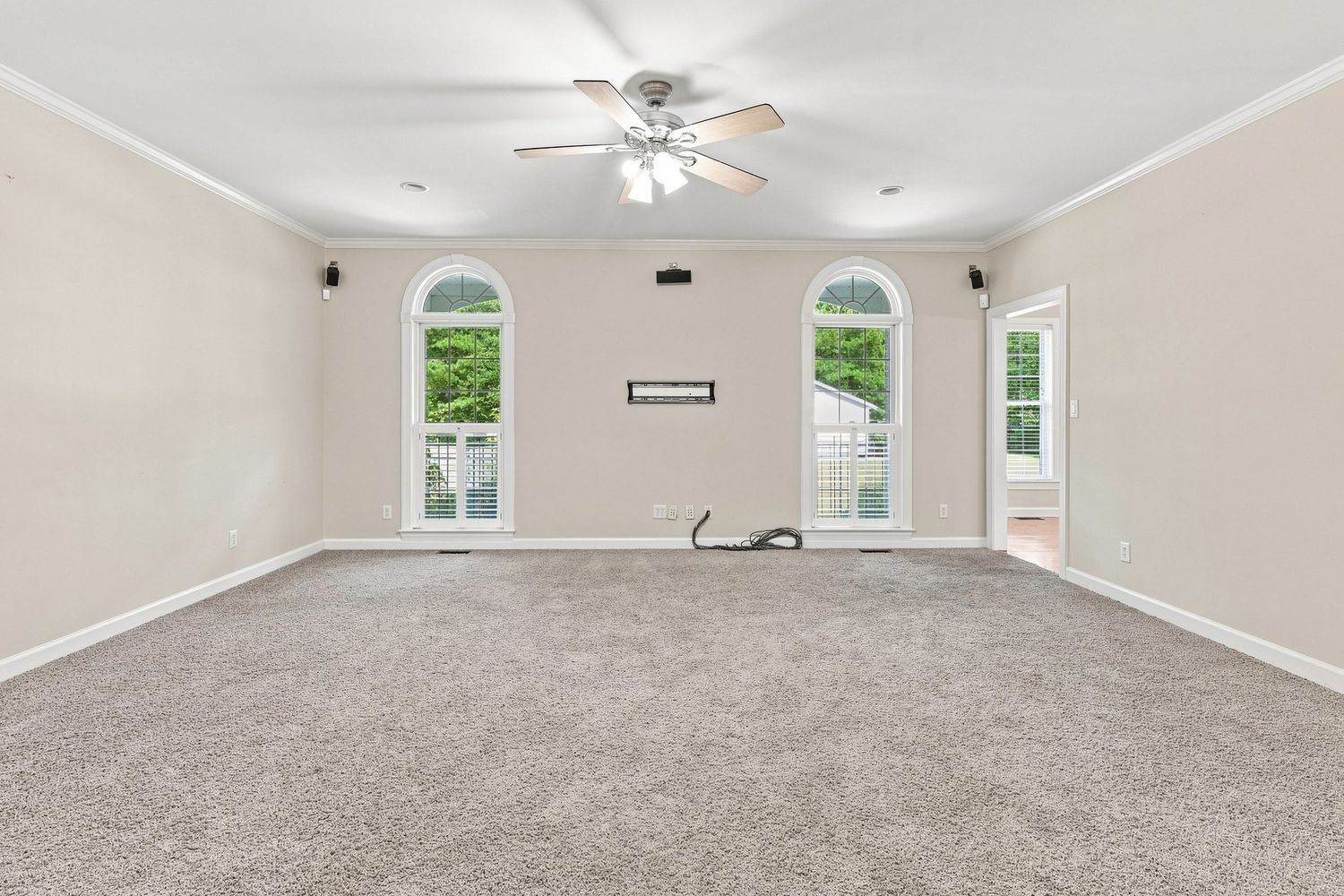 Spacious living room featuring natural window light and high ceilings, ideal for an Eastern NC real estate listing.