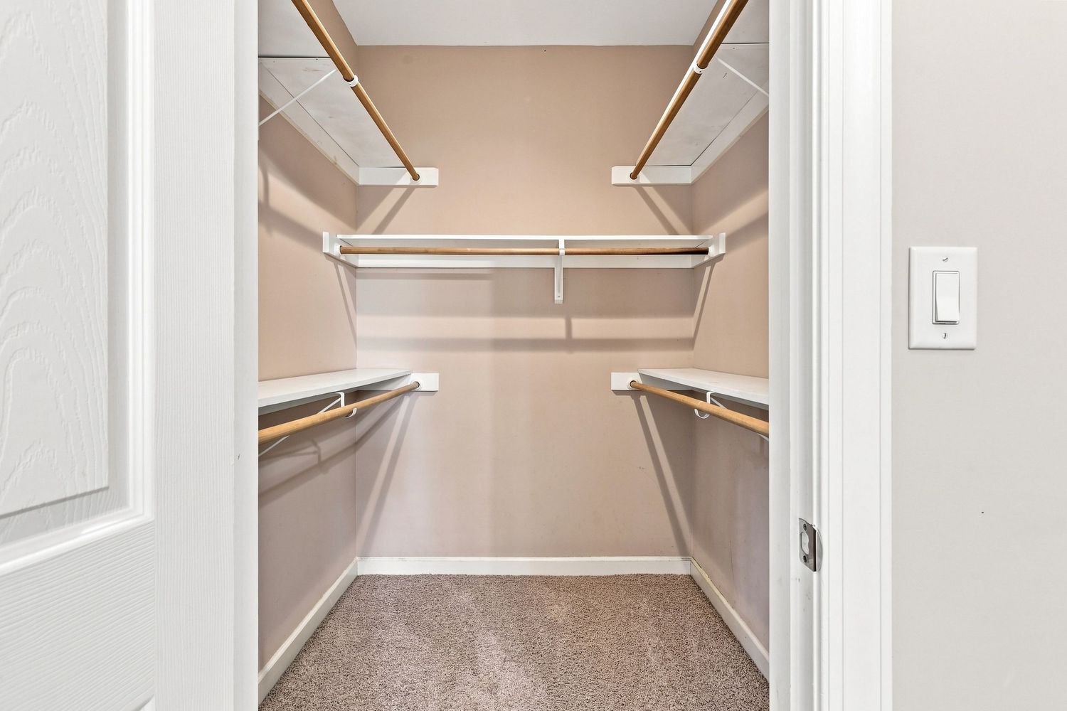Organized, clean bedroom closet layout emphasizing built-in shelving space for home buyers.
