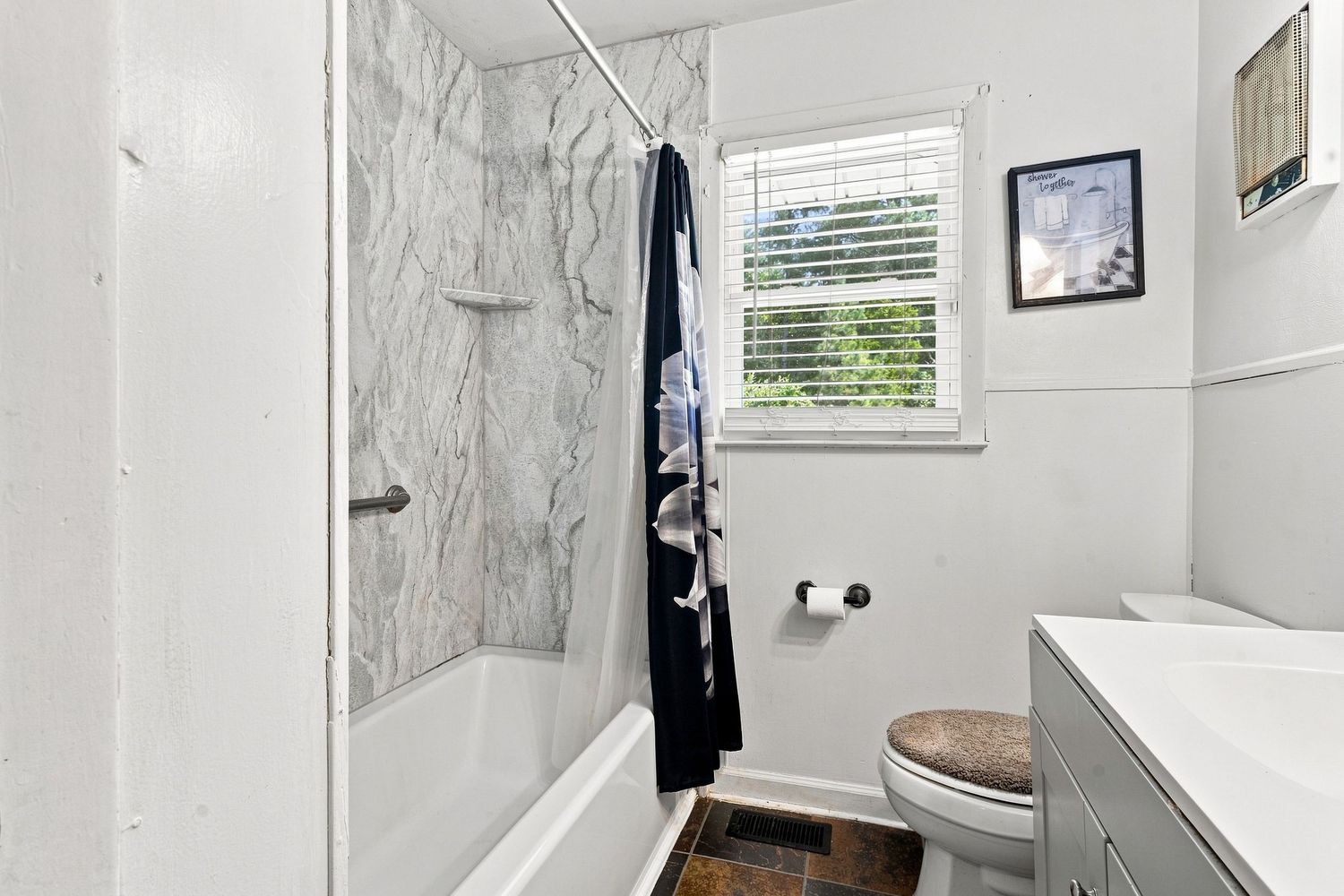 Modern primary bathroom with updated shower and clean fixtures for a NC property listing.