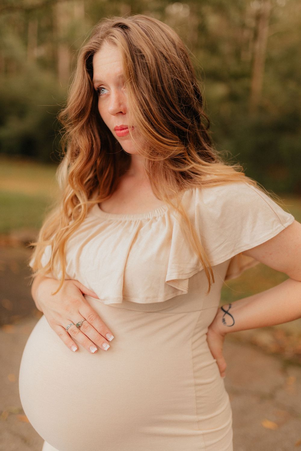 An outdoor maternity photoshoot of an expecting mother holding her baby bump at Berry College in Rome, Georgia by Ella Monroe Photography