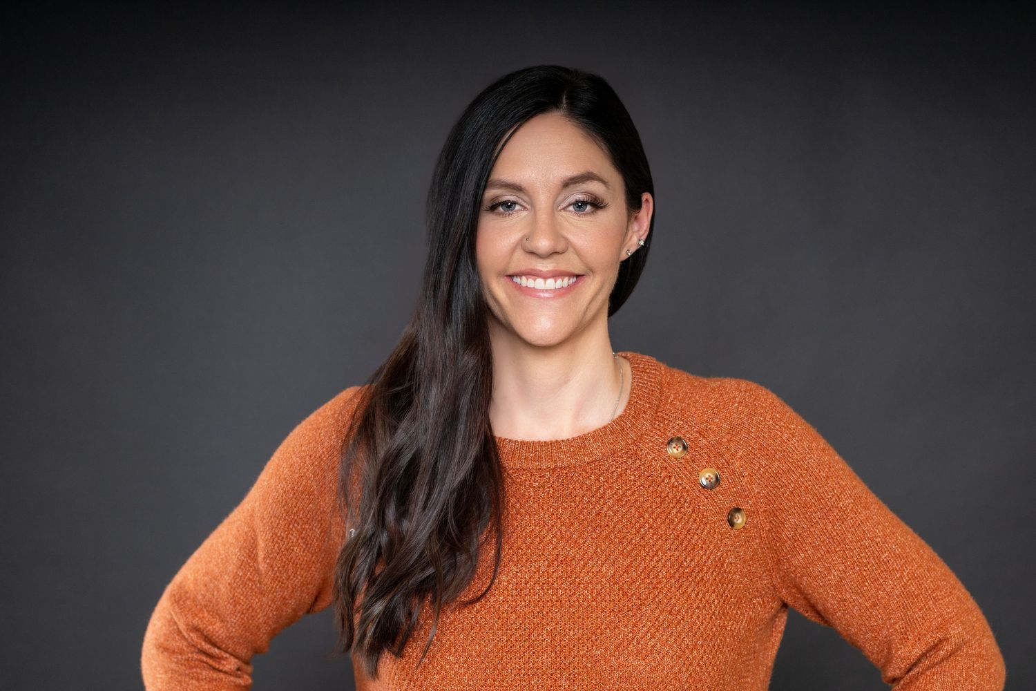 Professional branding headshot of a businesswoman photographed against a dark studio background