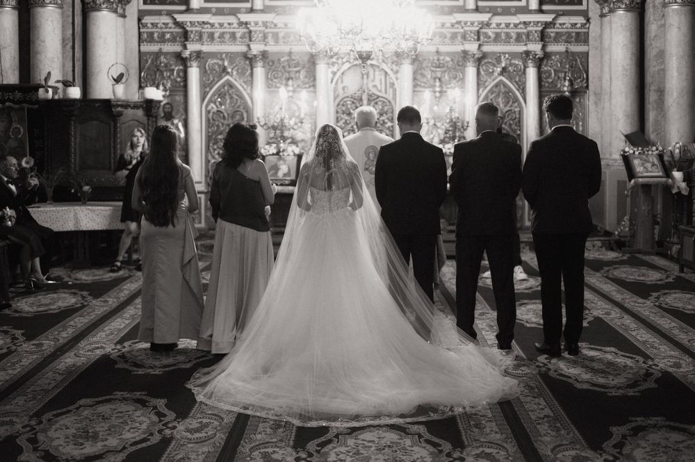 Black and white photo of a bride and groom standing at the altar during a church wedding ceremony.