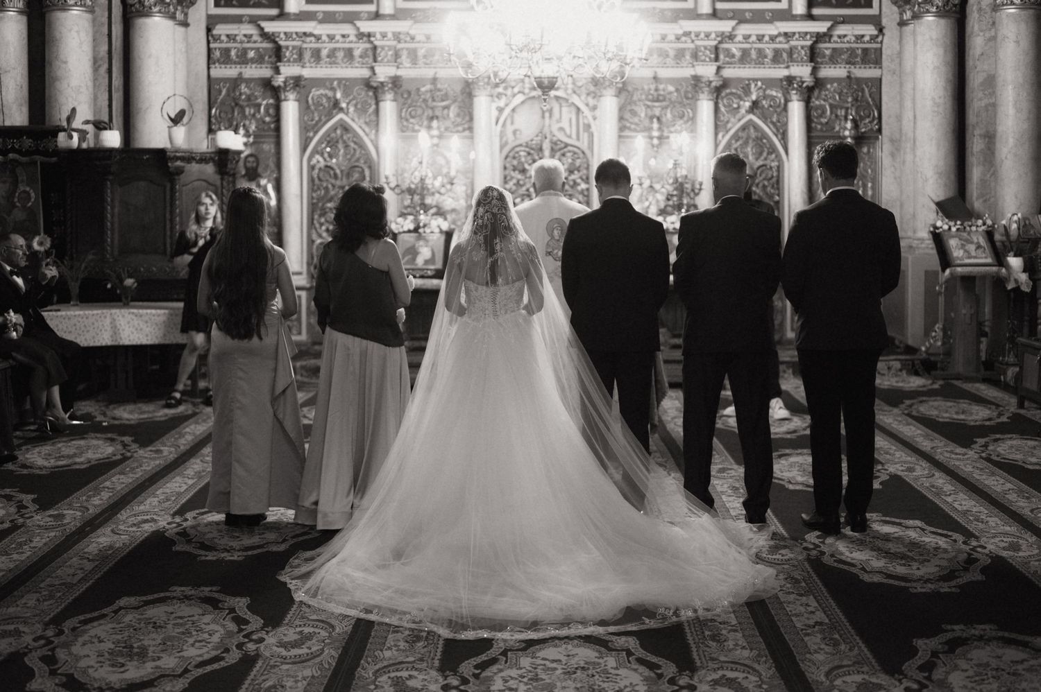 Black and white photo of a bride and groom standing at the altar during a church wedding ceremony.