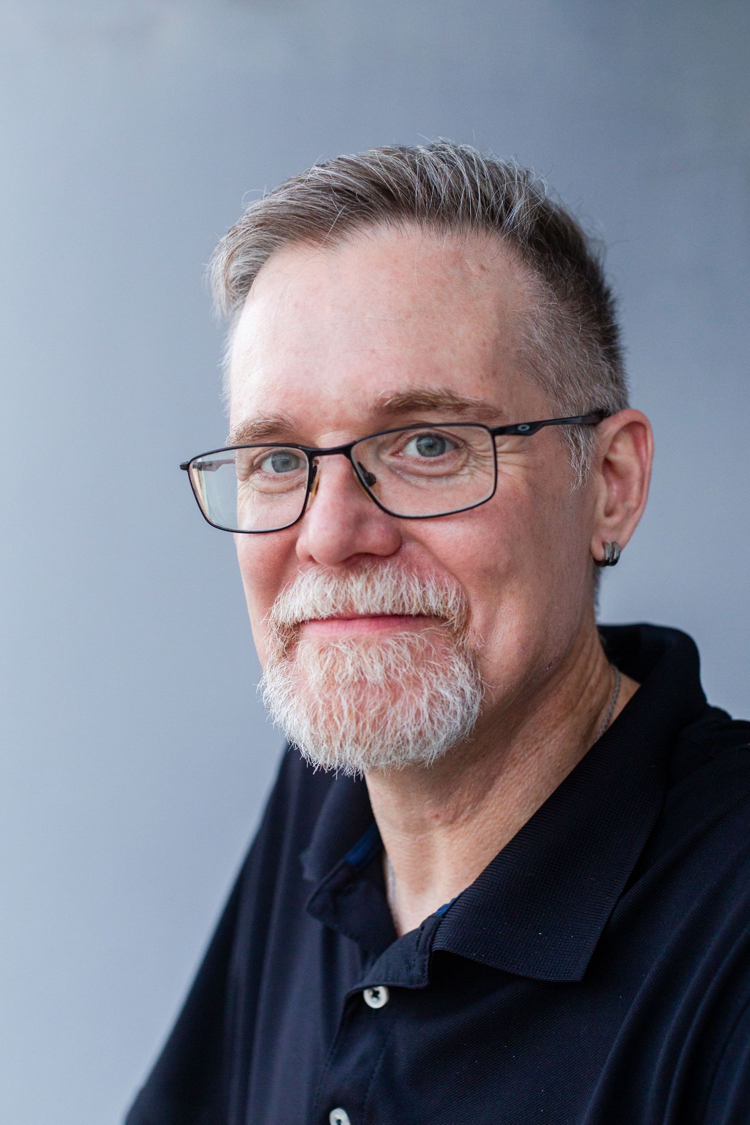 Headshot of a man against a gray background. Guaynabo, Puerto Rico.