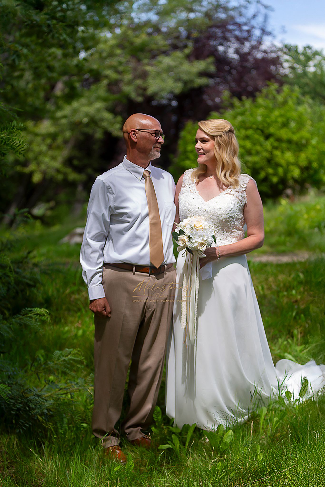 bride and groom looking at each other Milestones Studios LLC