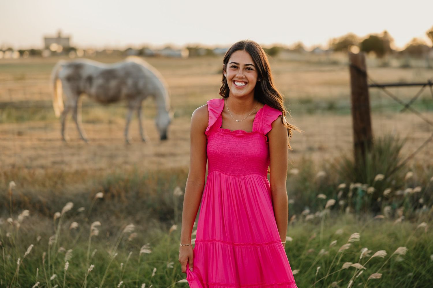 Country senior portraits in Tulia, Texas with horses and an open field.