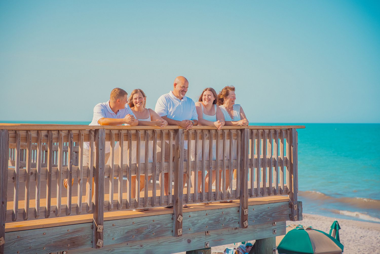 A family laughs together during a photo session at a Disney Vacation Resort in Vero Beach, Florida.