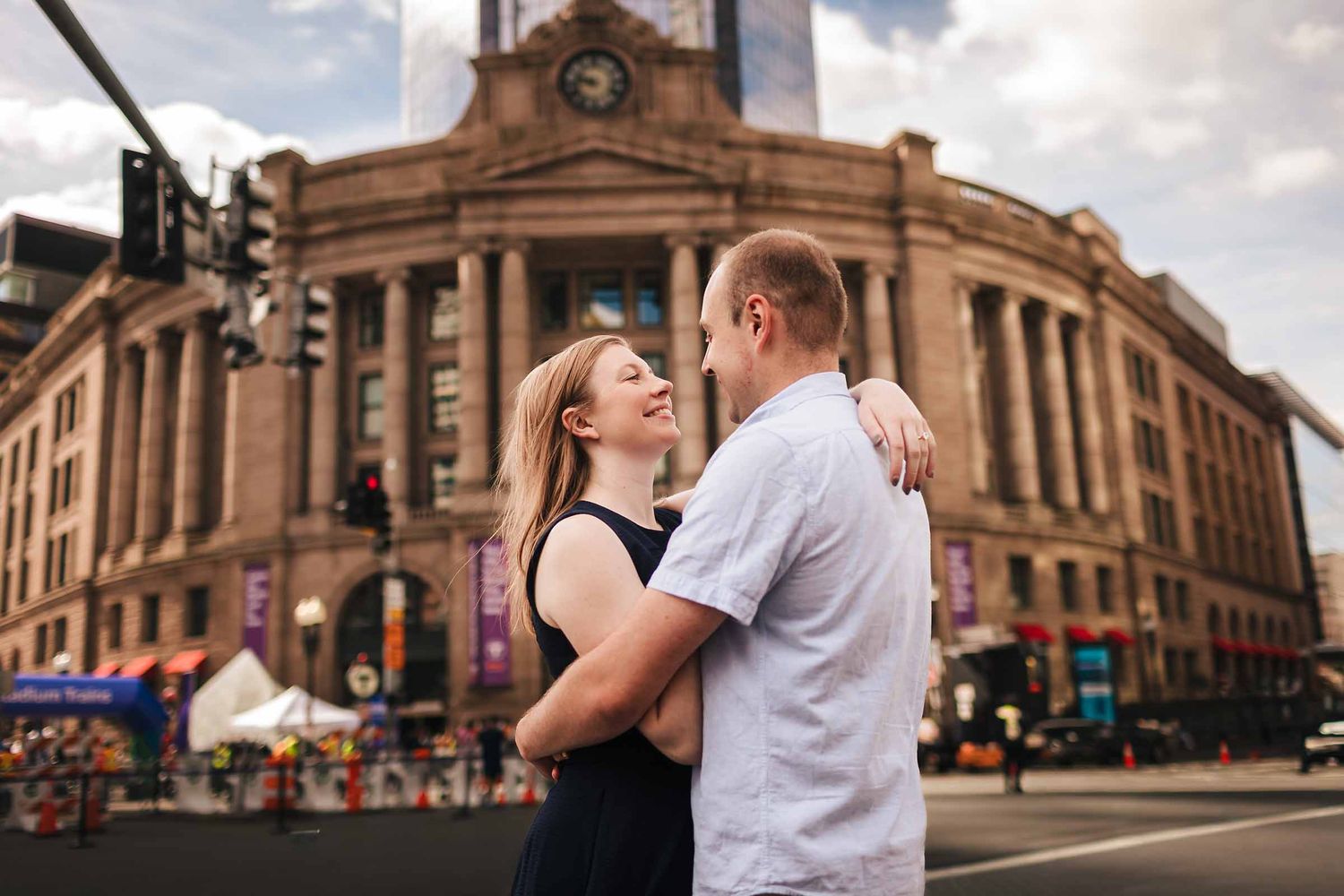 Engaged couple laughing together near South Station in downtown Boston
