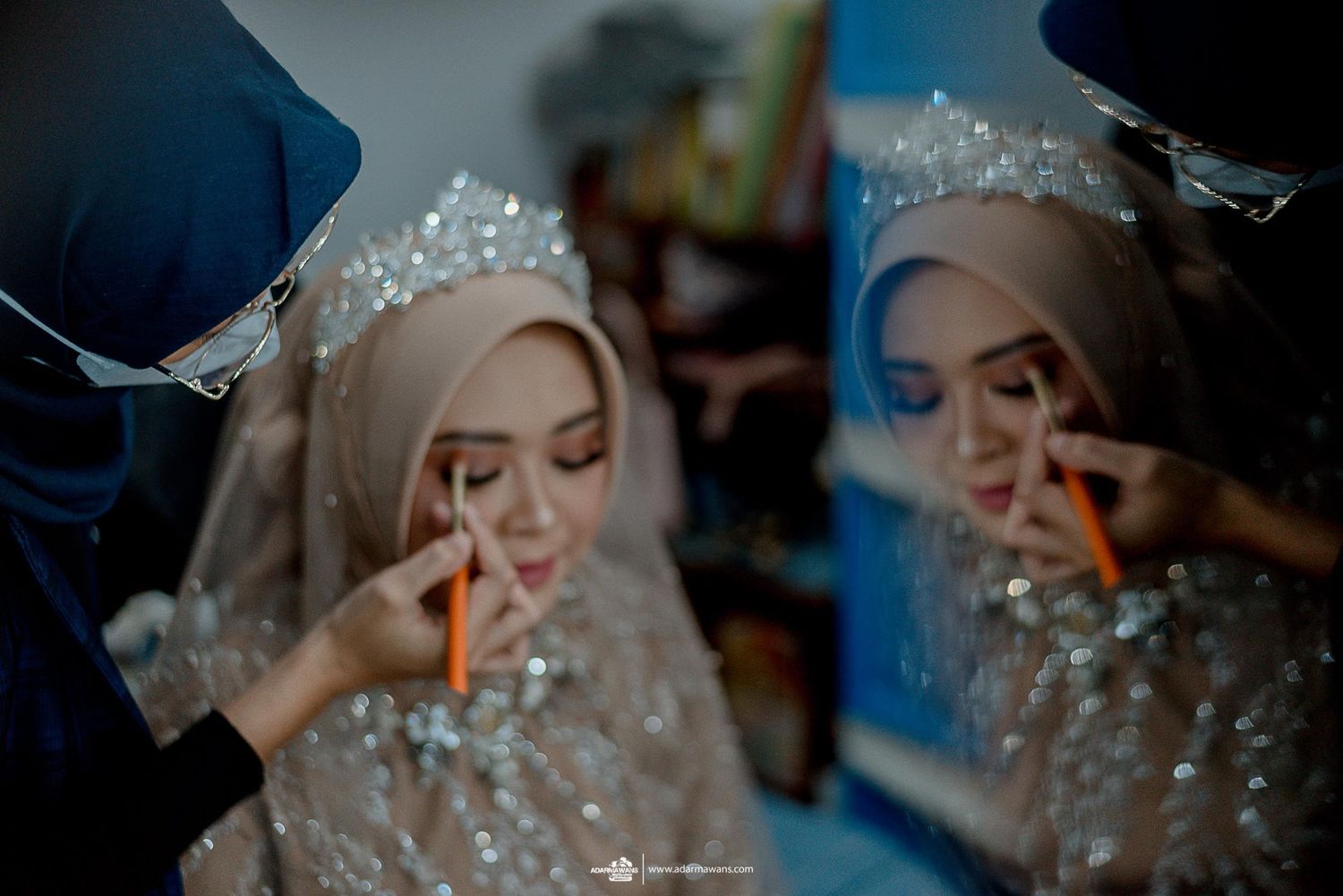 Close-up shot of makeup application during a wedding preparation.