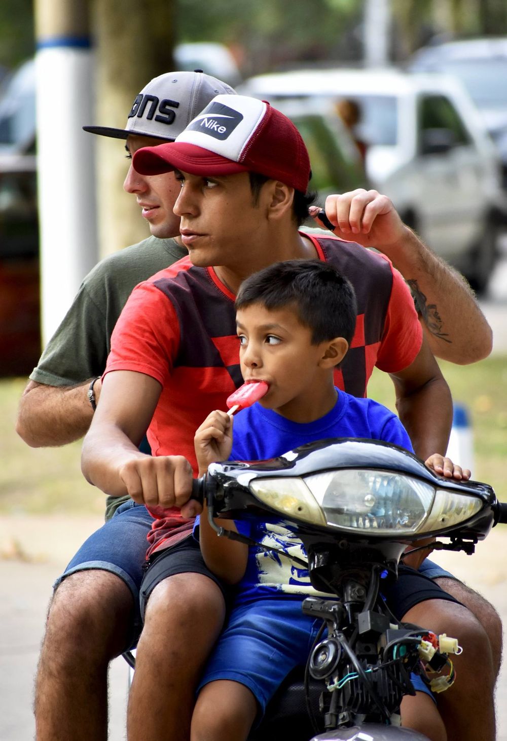Two men and a boy on a bike